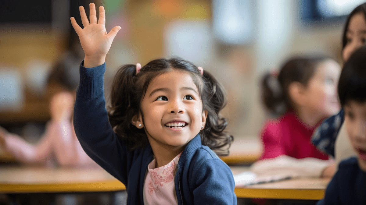 Child raising hand eagerly in classroom